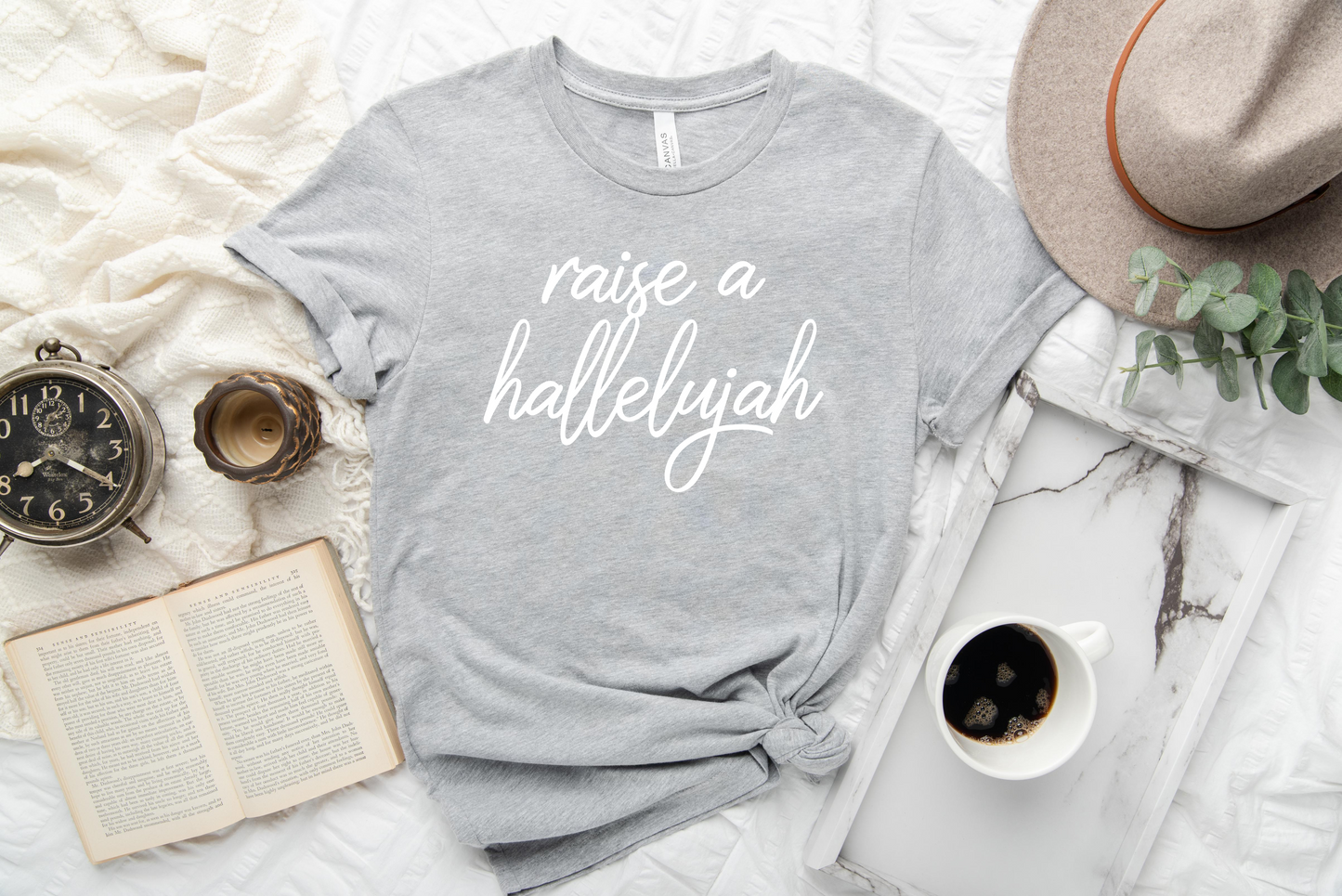 raise a hallelujah tee shirt flatlay design on a grey graphic tee