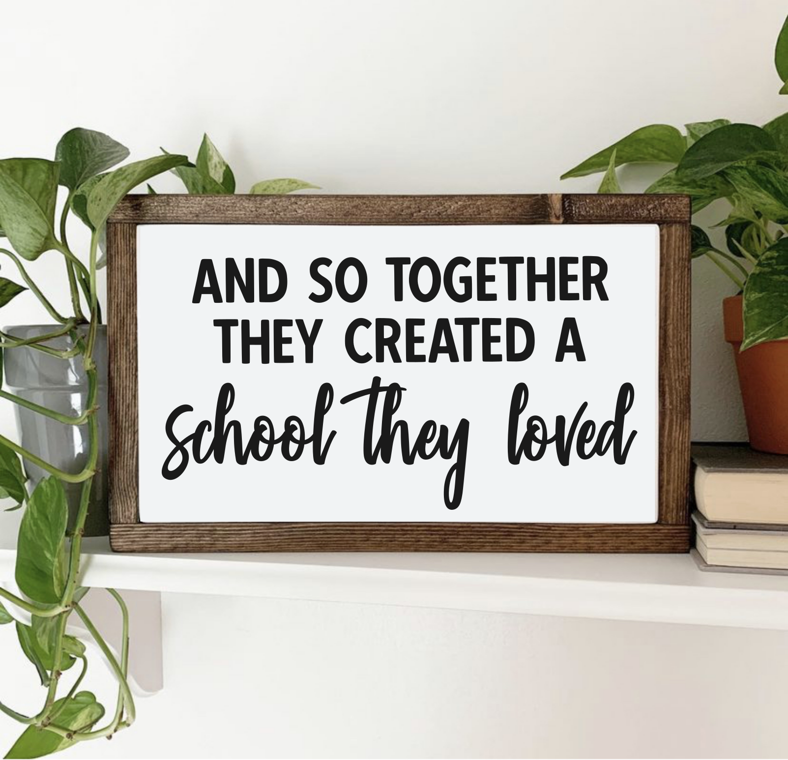 rectangular wooden framed plaque sign decor with the words "and so together they created a school they loved" in a bold print and creative script font