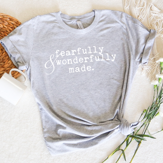 fearfully and wonderfully made printed typewriter style faith base graphic tee shirt.  Christian apparel style on Bella Canvas athletic grey tee with inspirational quote words and scripture 